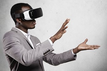 Tech professional testing a VR headset to see how this technology can be used in the workplace
