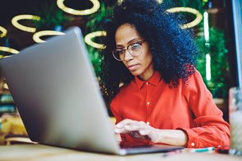 Female CIO on her laptop planning on how to overcome the challenges of digital transformation