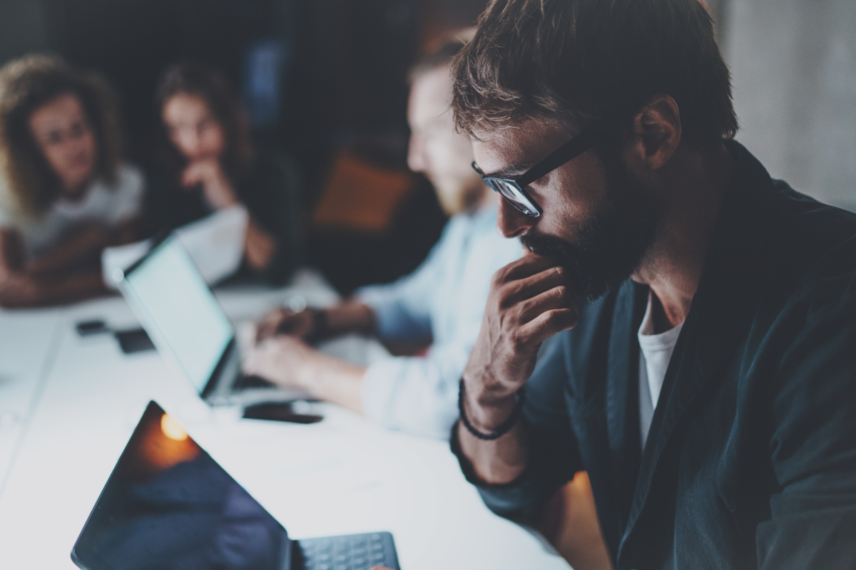 Confused IT leader looking at laptop trying to understand why digital transformation isn't working
