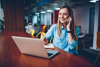 Happy IT professional smiling because she has successfully developed a digital workspace strategy