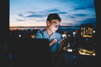 Tech worker staying connected with her colleagues remotely using face to face video software
