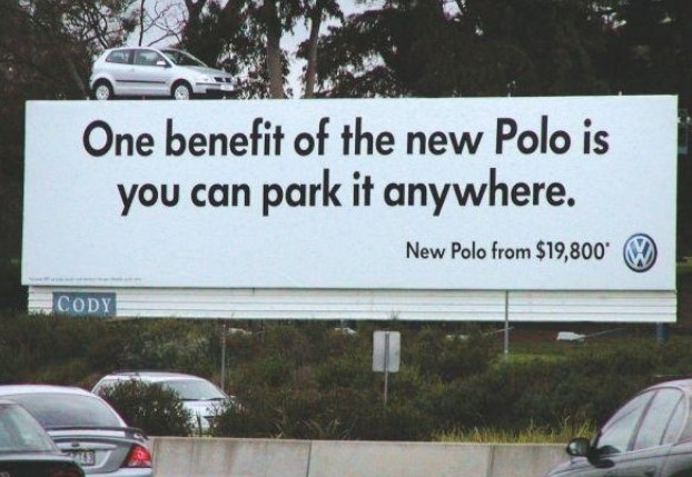 Billboard ad showing a VW Polo parked on top, hinting that you can park the car anywhere