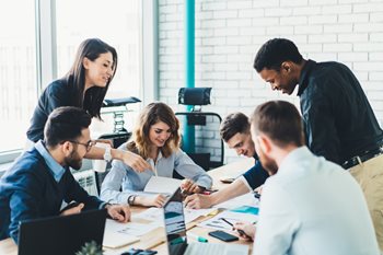 Successful group of tech professionals learning from one another to upskill themselves